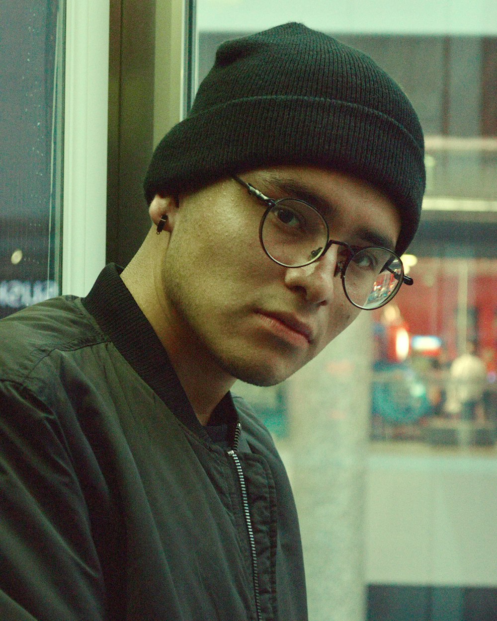 man in black knit cap and black framed eyeglasses