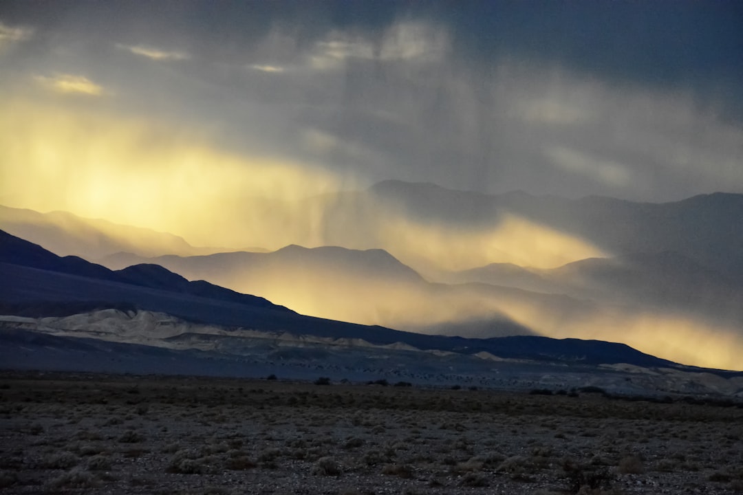 white clouds over snow covered mountains