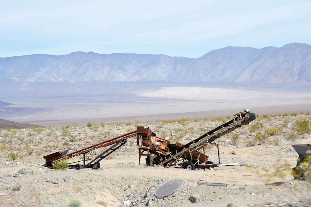 brown metal machine on brown sand during daytime