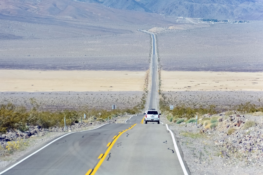 white car on gray asphalt road during daytime