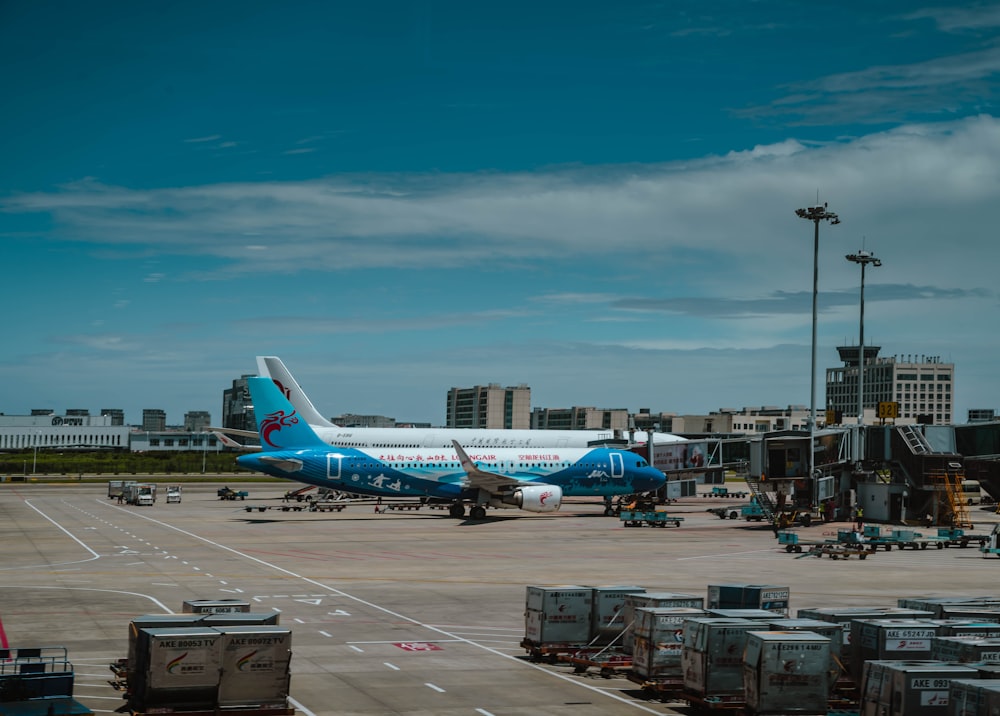 white and blue airplane on airport during daytime