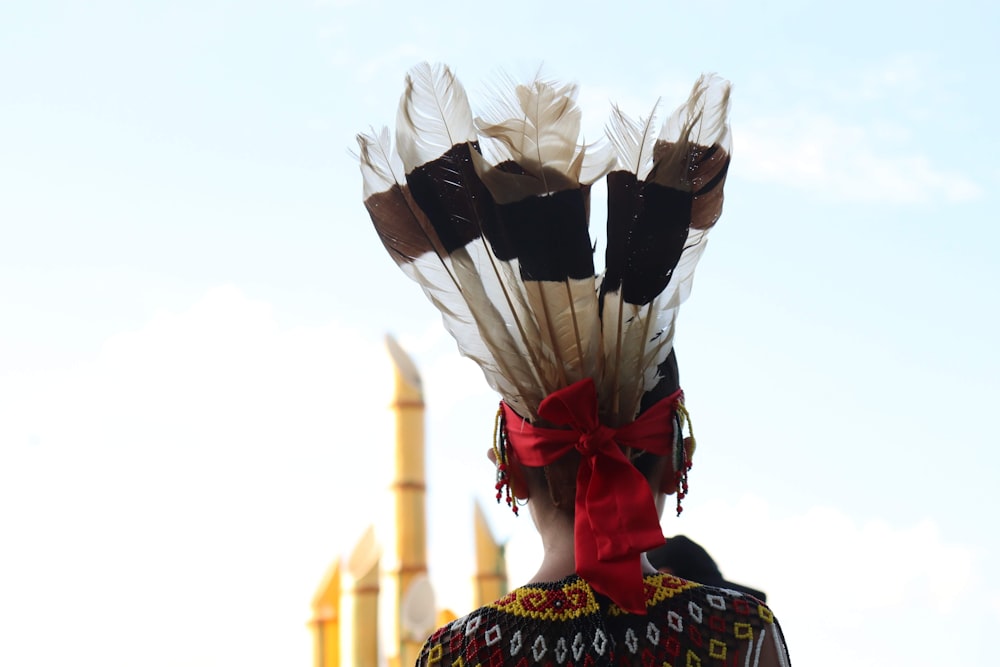 woman in red and gold dress with white wings