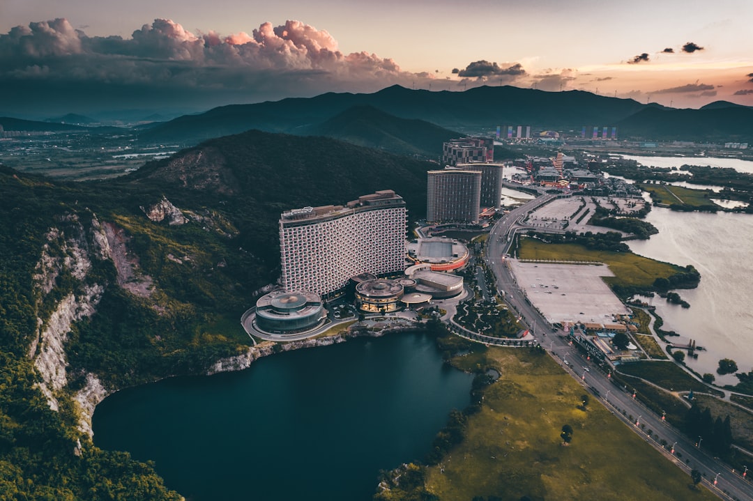 aerial view of city buildings near body of water during daytime