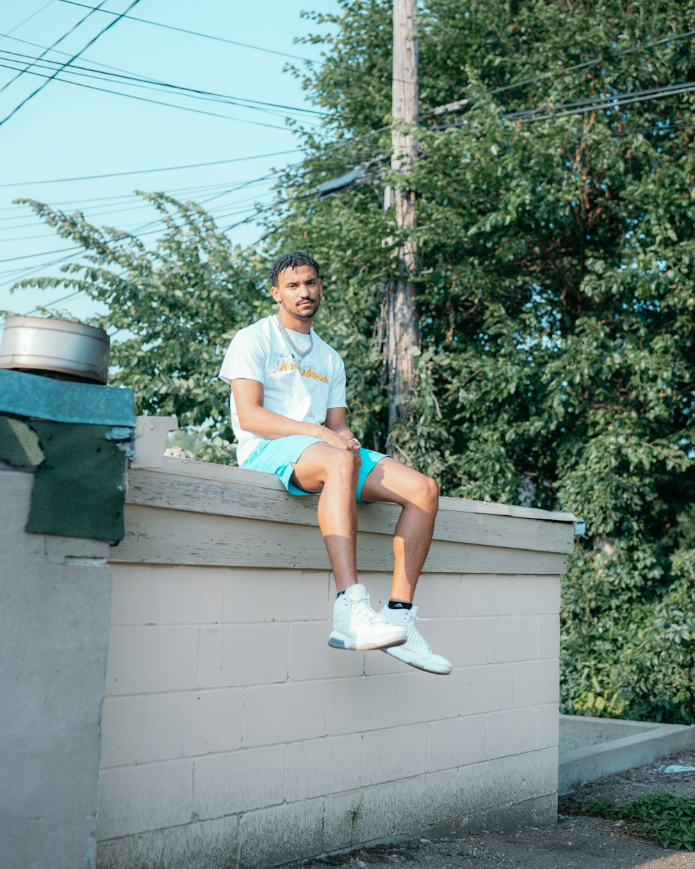 woman in white t-shirt sitting on white concrete bench