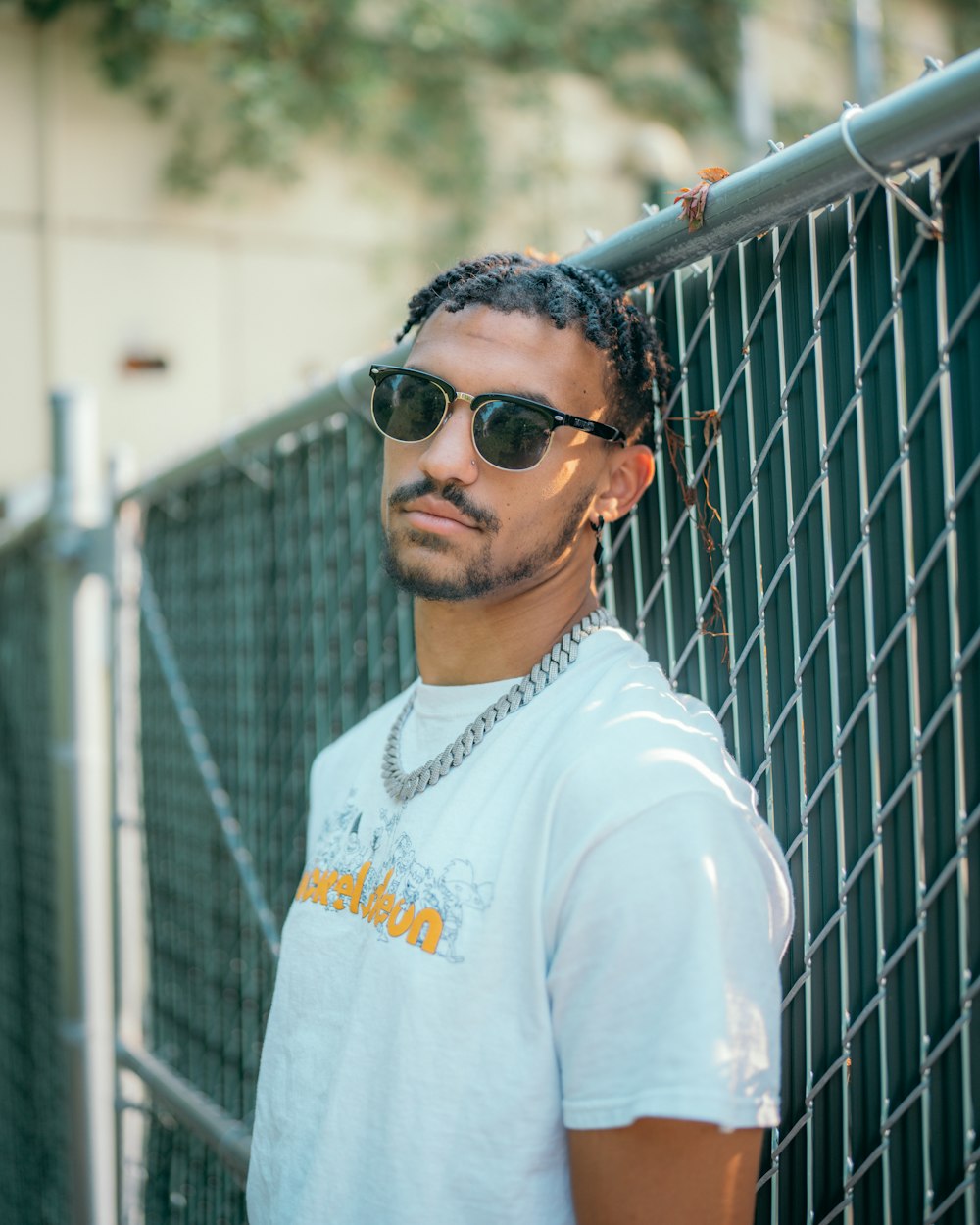 man in white crew neck shirt wearing black sunglasses