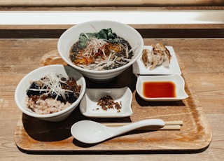 white ceramic bowl with food on brown wooden table