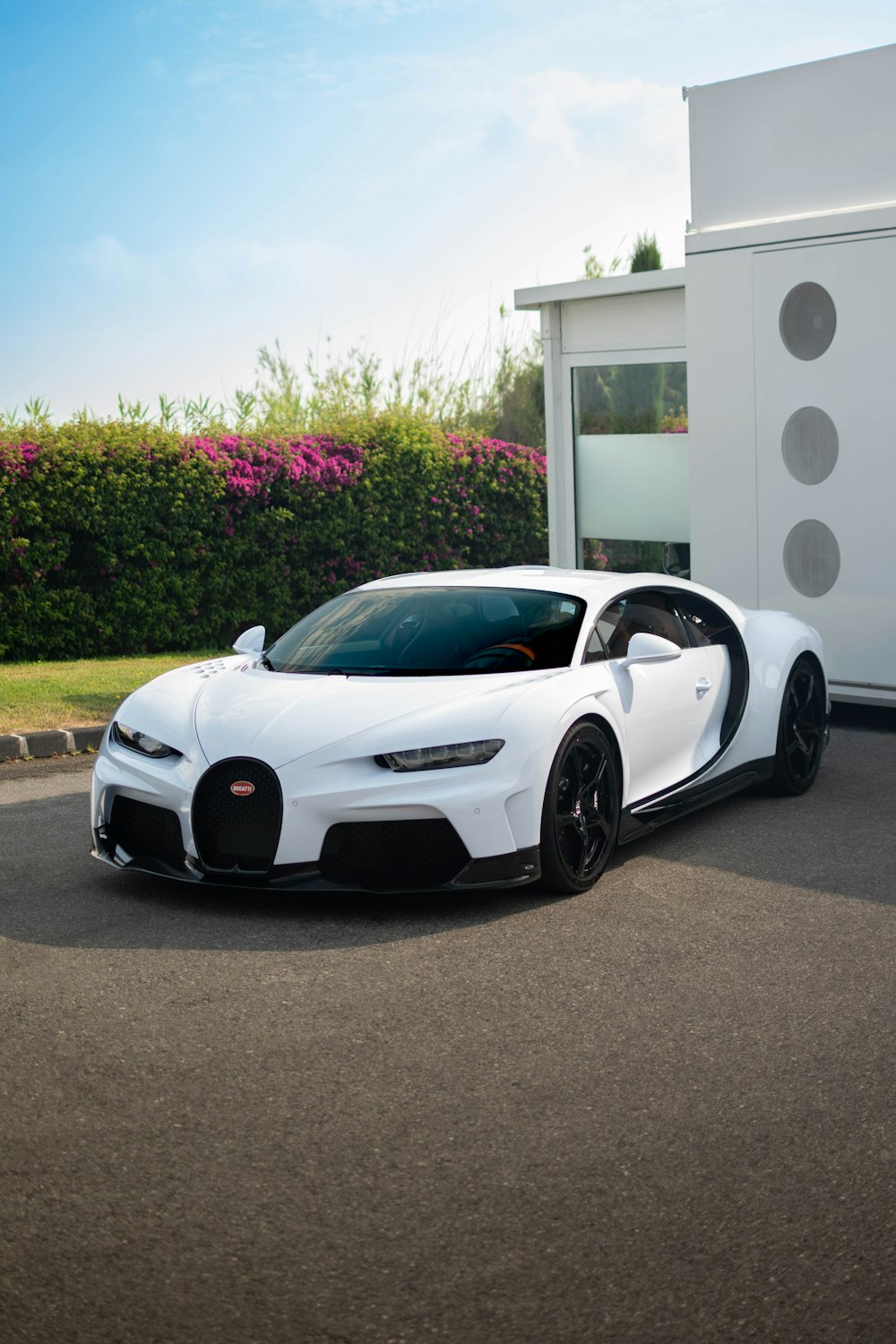 white lamborghini aventador parked near white concrete building during daytime