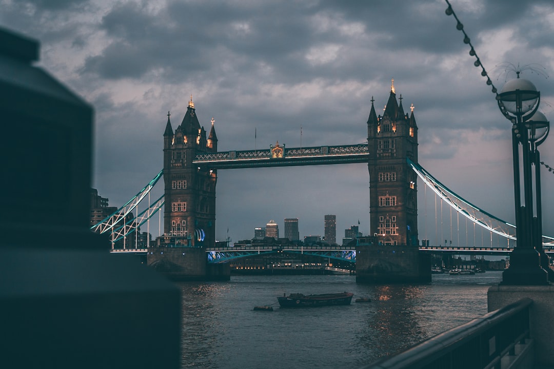 bridge over water under cloudy sky during daytime