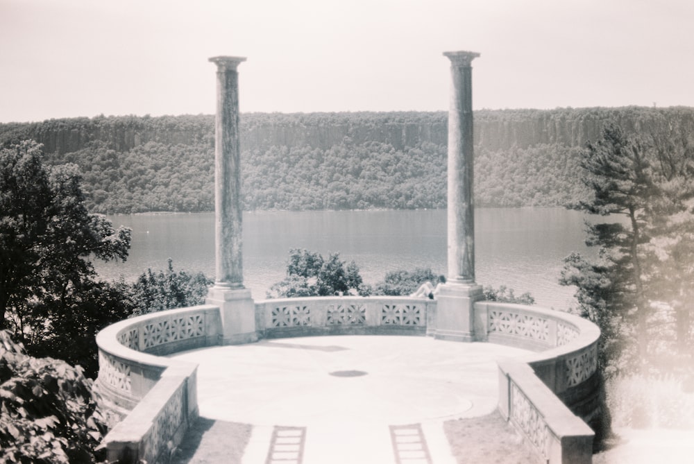 white concrete outdoor fountain near body of water during daytime