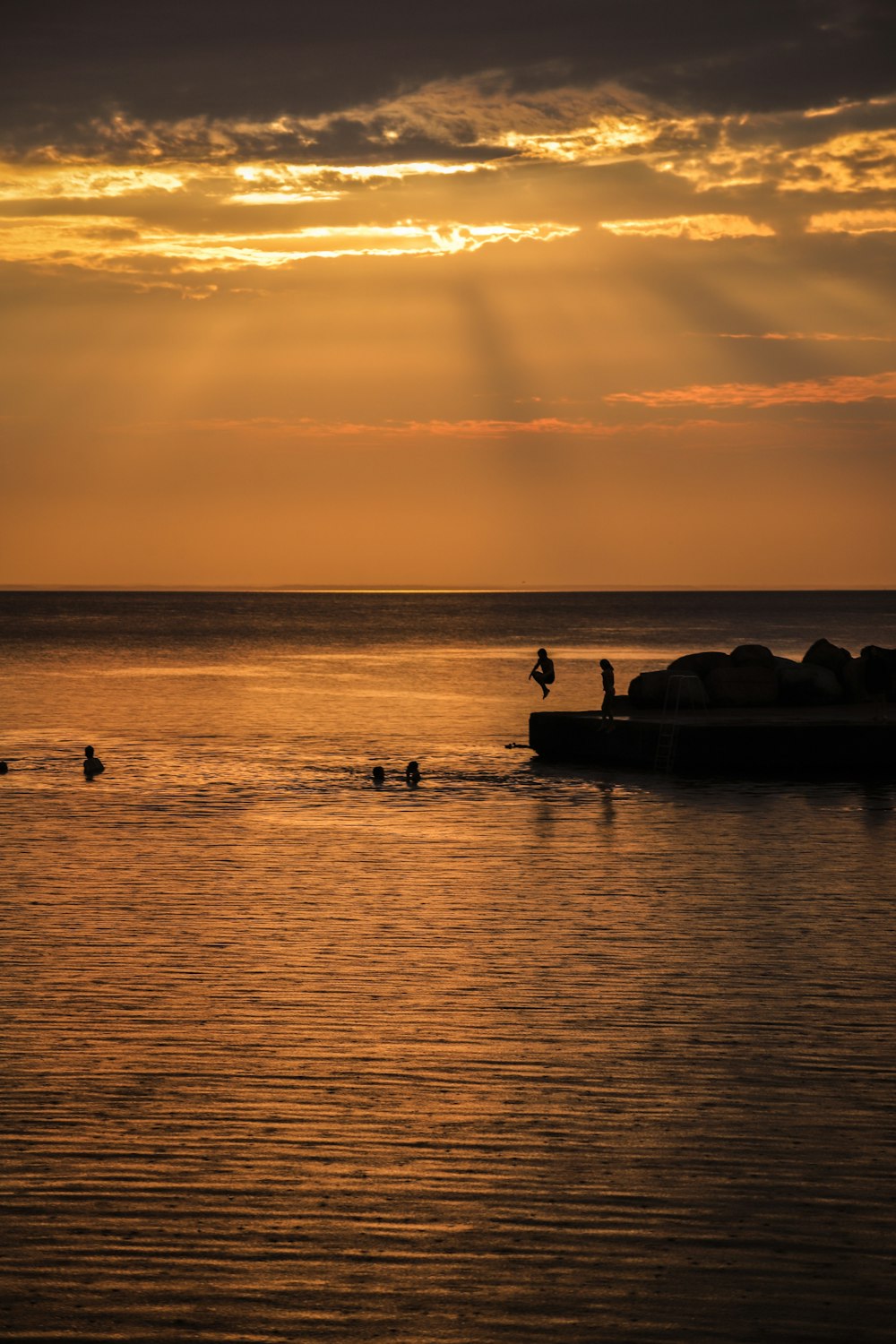 silhouette of people on boat during sunset