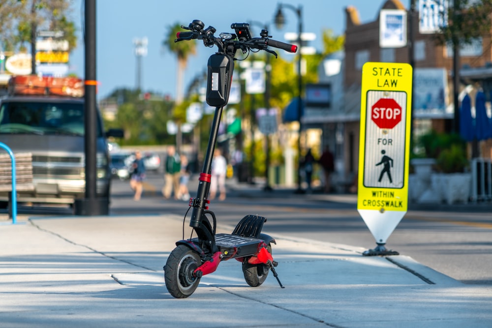 black and red motorcycle on road during daytime