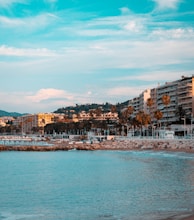 city buildings near body of water under blue sky during daytime