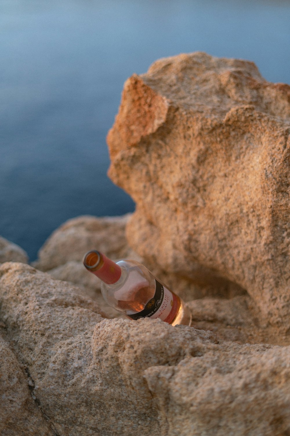 clear glass bottle on brown rock