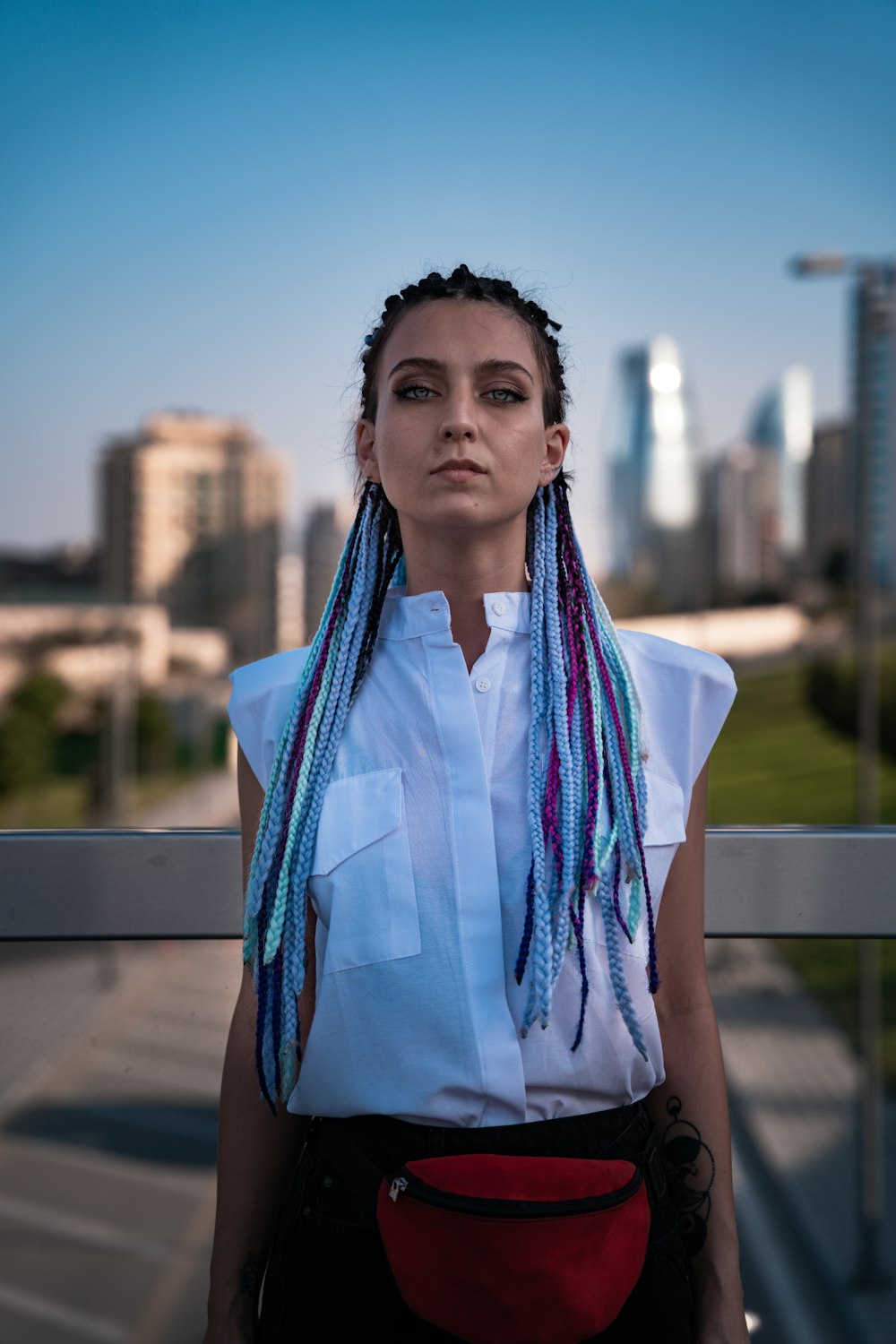 woman in white and blue scarf standing near gray metal railings during daytime