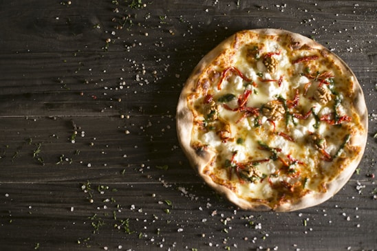 A delicious pizza with fresh ingredients on a wooden table.