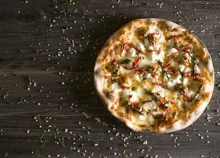 pizza with cheese and green leaves