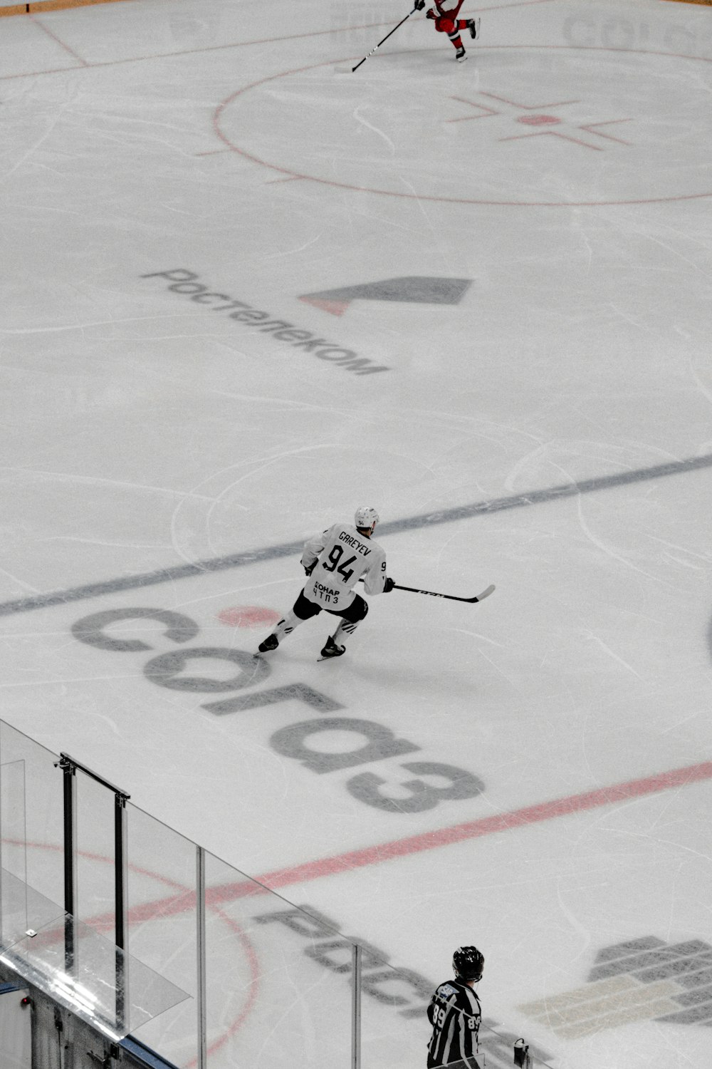 man in white ice hockey jersey riding on ice hockey field