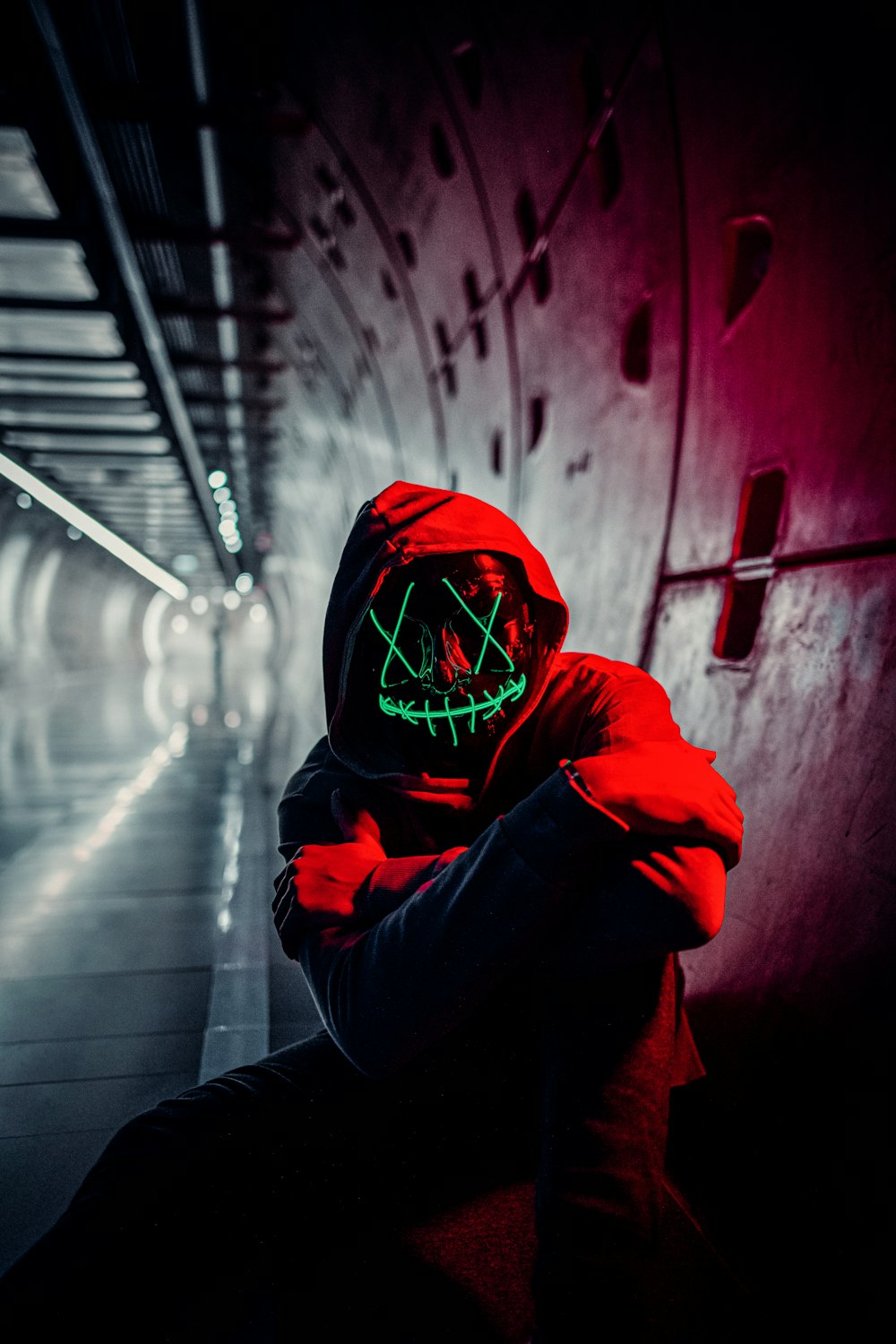 person in red hoodie wearing red mask