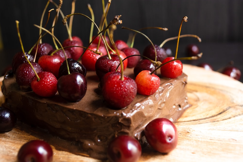 red cherries on brown wooden surface