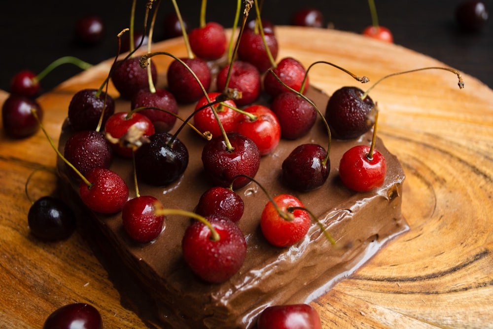 red cherries on brown wooden surface