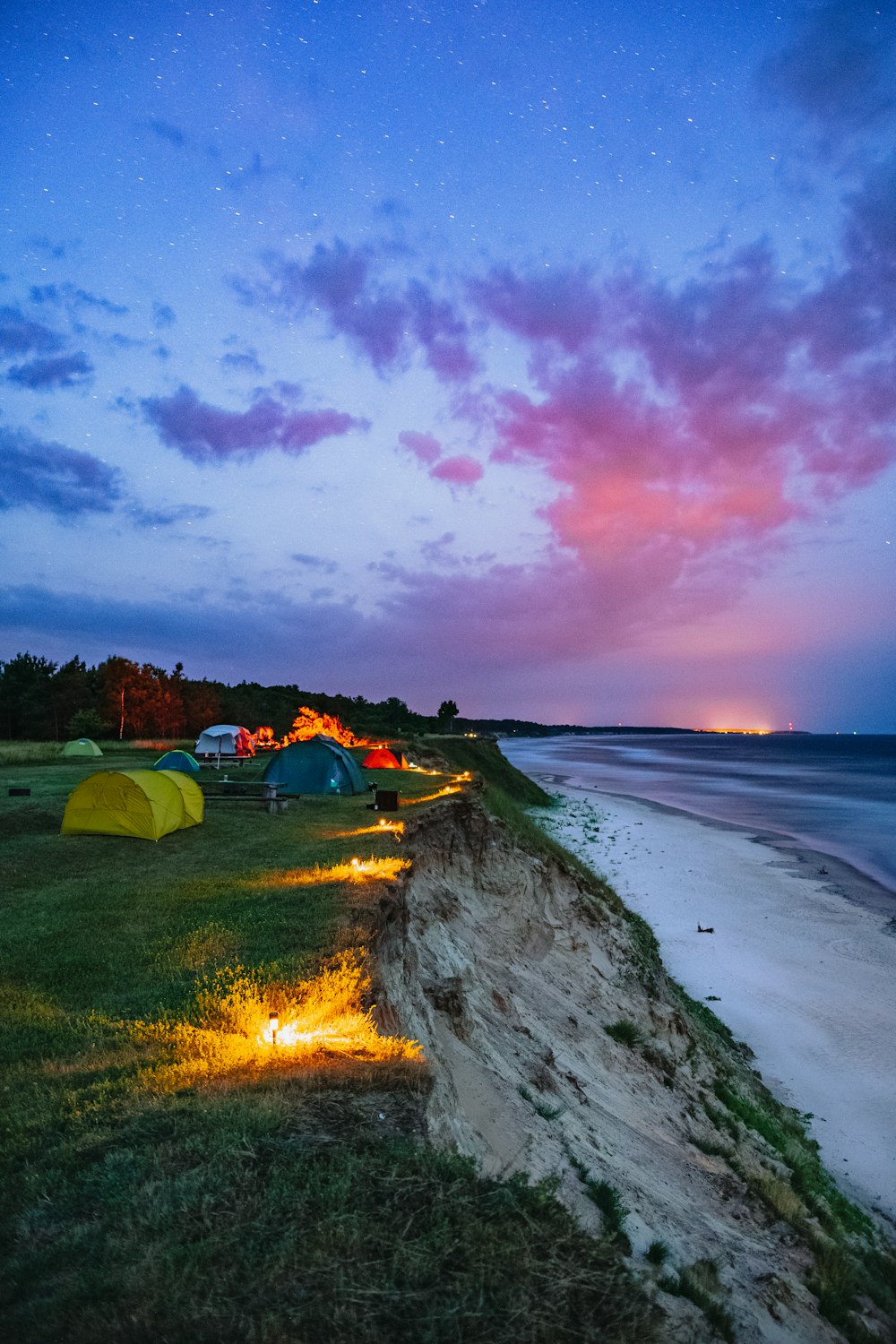 green tent on seashore during sunset