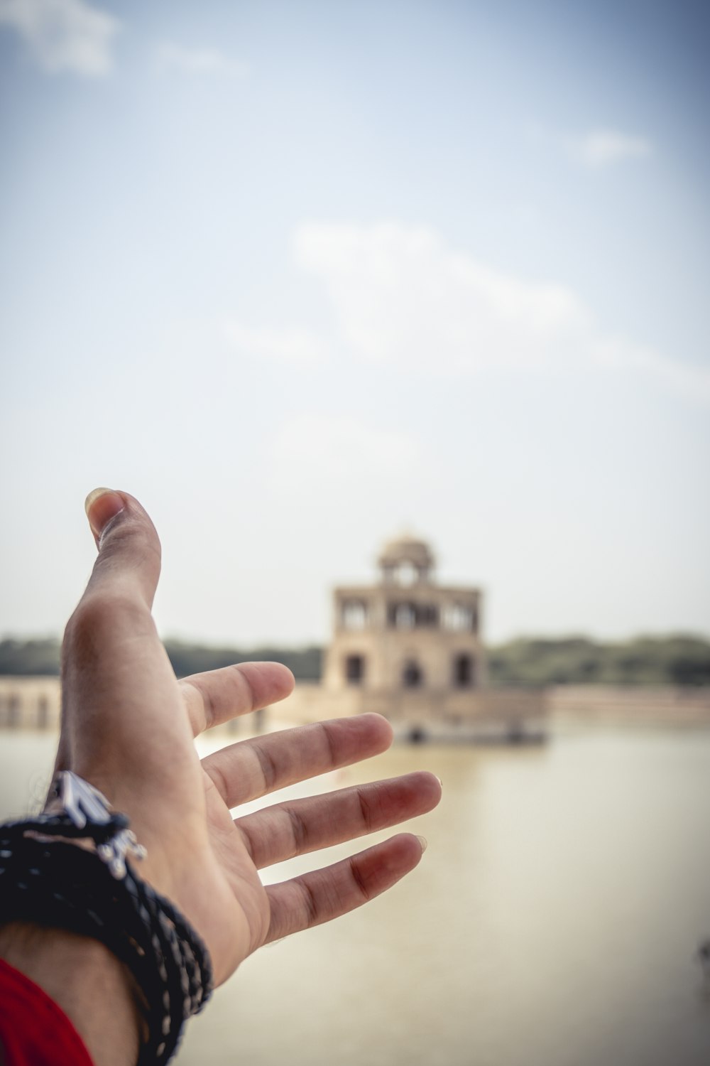 persons left hand near body of water during daytime