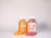Two clear jars with white lids contain colorful gummies. The left jar is labeled 'Turmeric & Ginger' and has orange gummies, while the right jar labeled 'Collagen Gummies' holds red gummies. A few gummies are scattered in front of each jar.