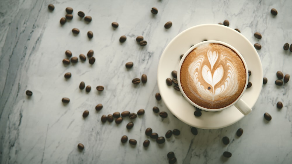 white ceramic cup with brown liquid on white ceramic saucer