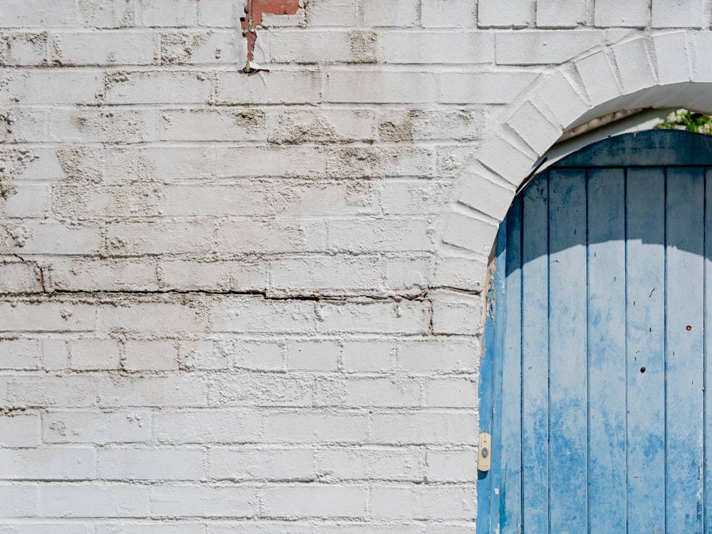 a blue and white door and a brick wall