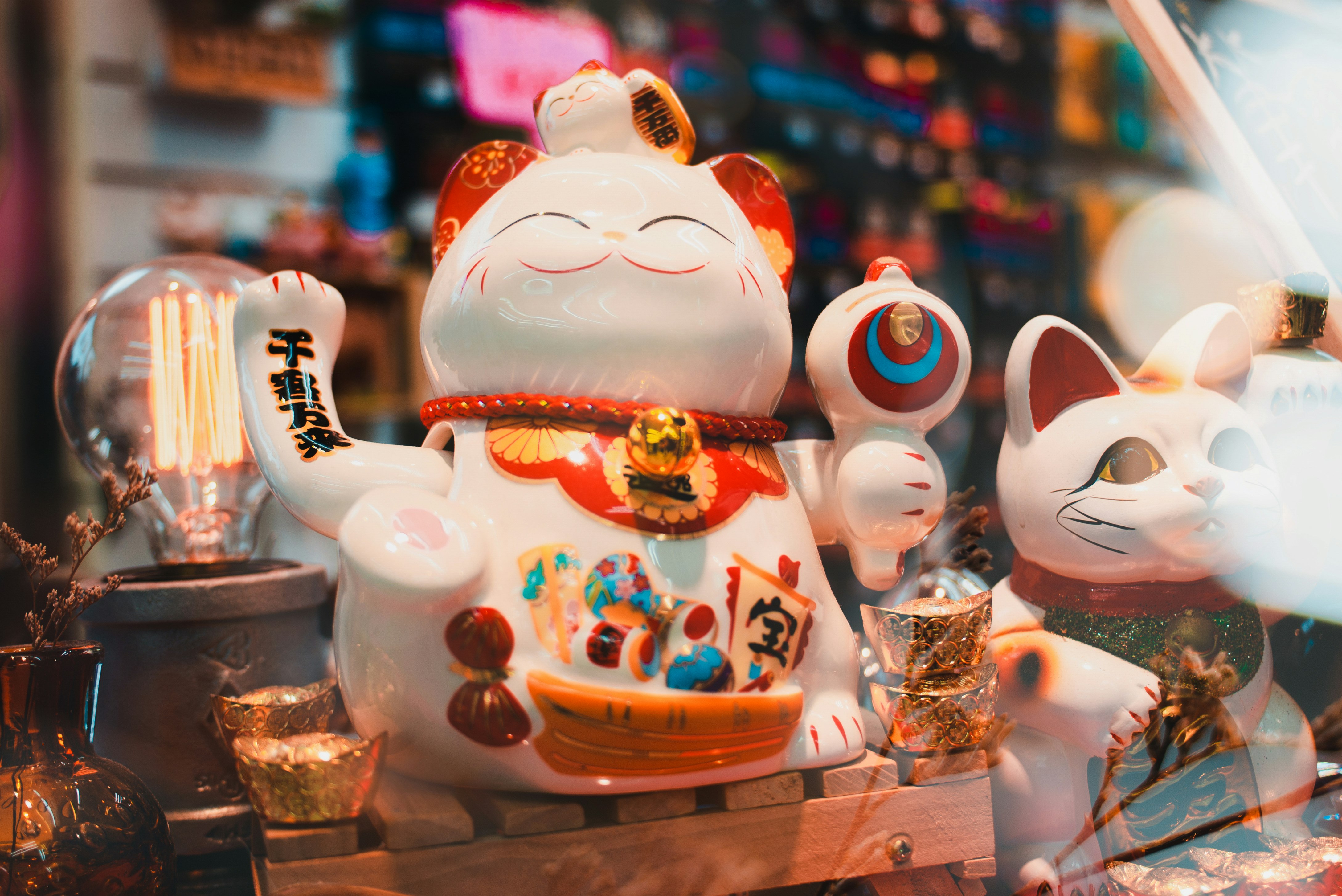 white ceramic cat figurines on brown wooden table