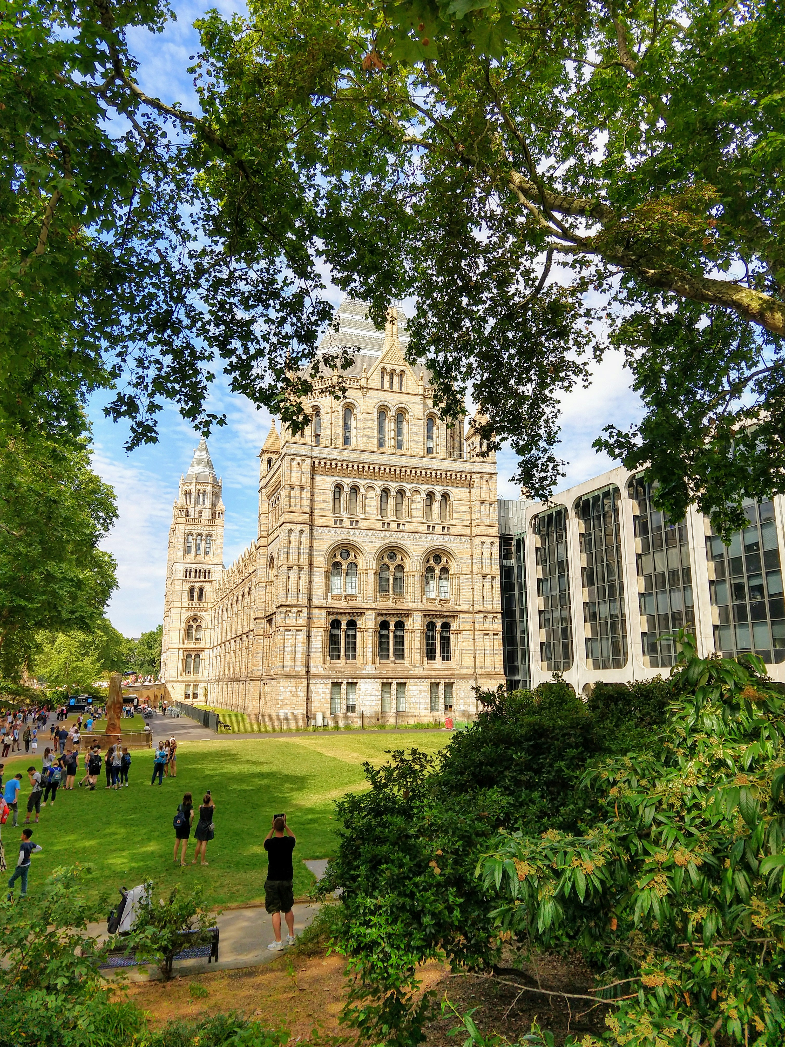 people walking on park near white concrete building during daytime