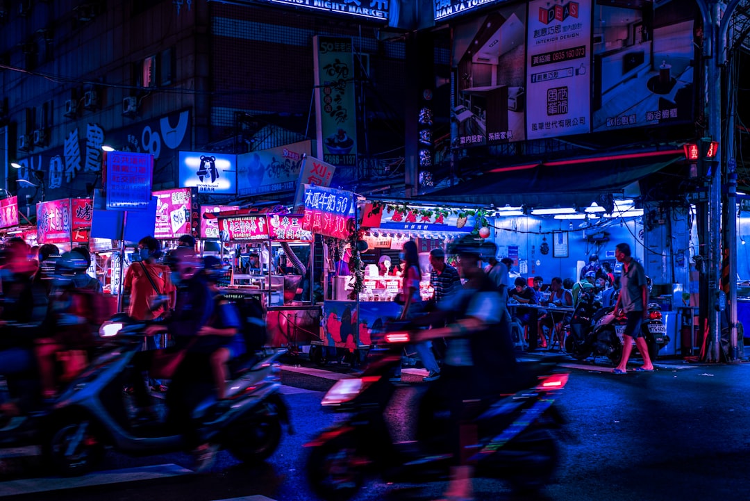 people riding motorcycle on street during nighttime