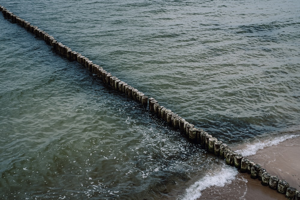 brown wooden dock on body of water during daytime