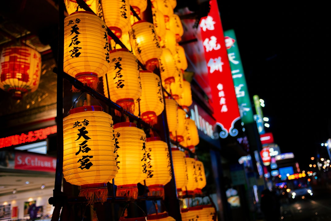 yellow paper lanterns on street during nighttime
