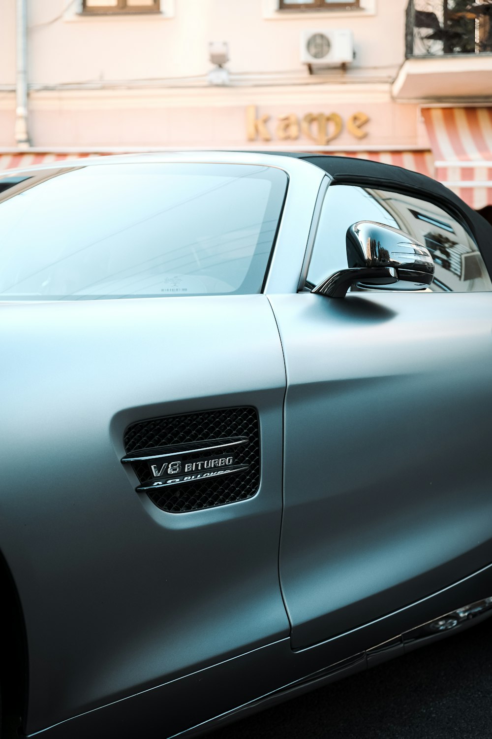 white audi r 8 parked on gray pavement during daytime