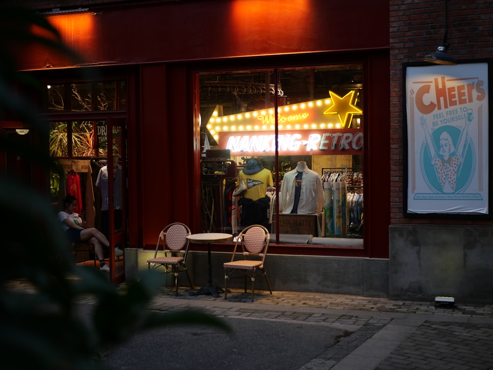 people sitting on chair outside store during nighttime