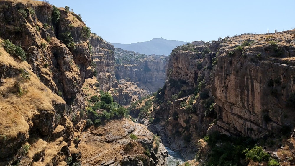 river between mountains during daytime