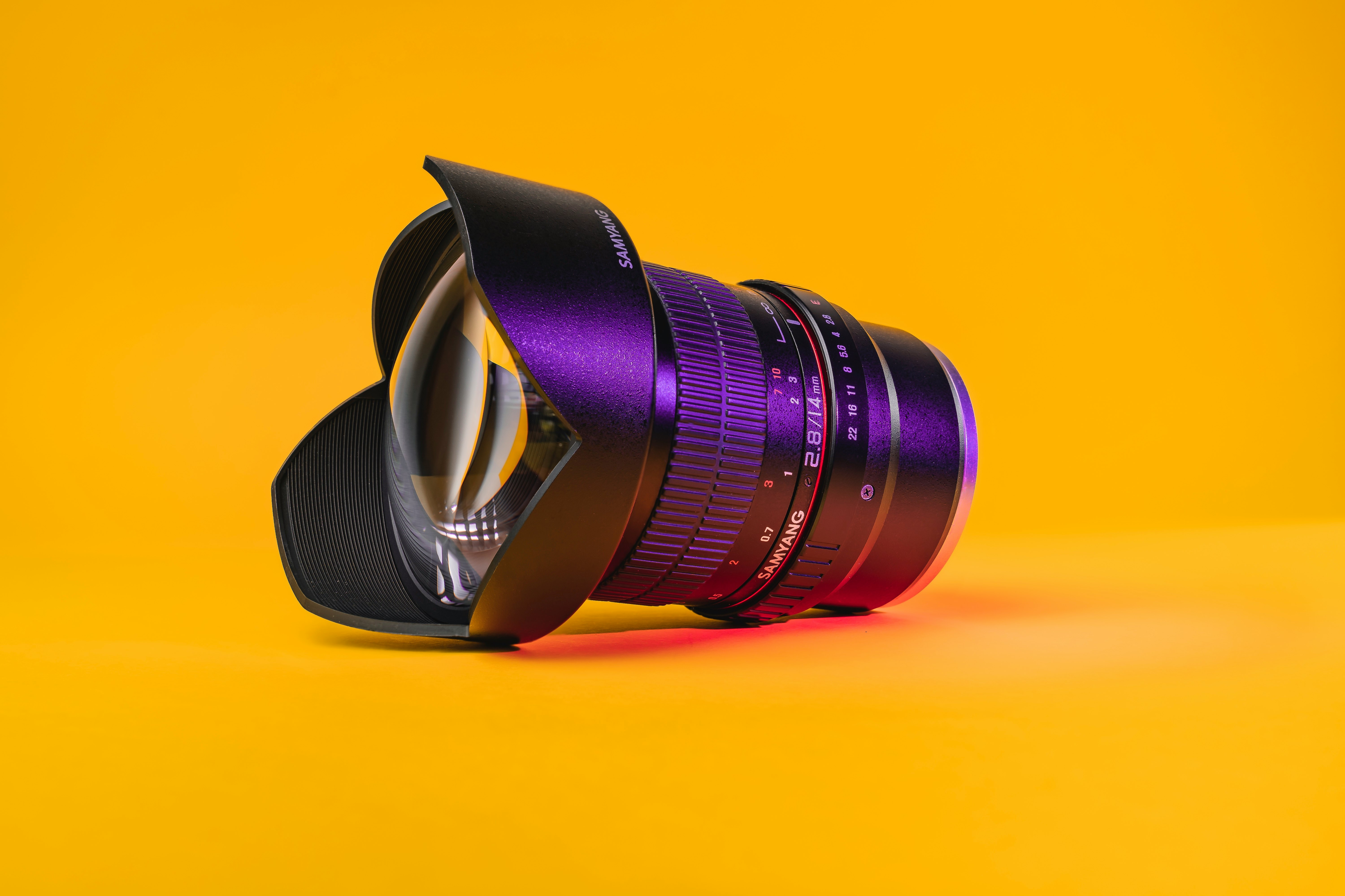 black camera lens on yellow surface