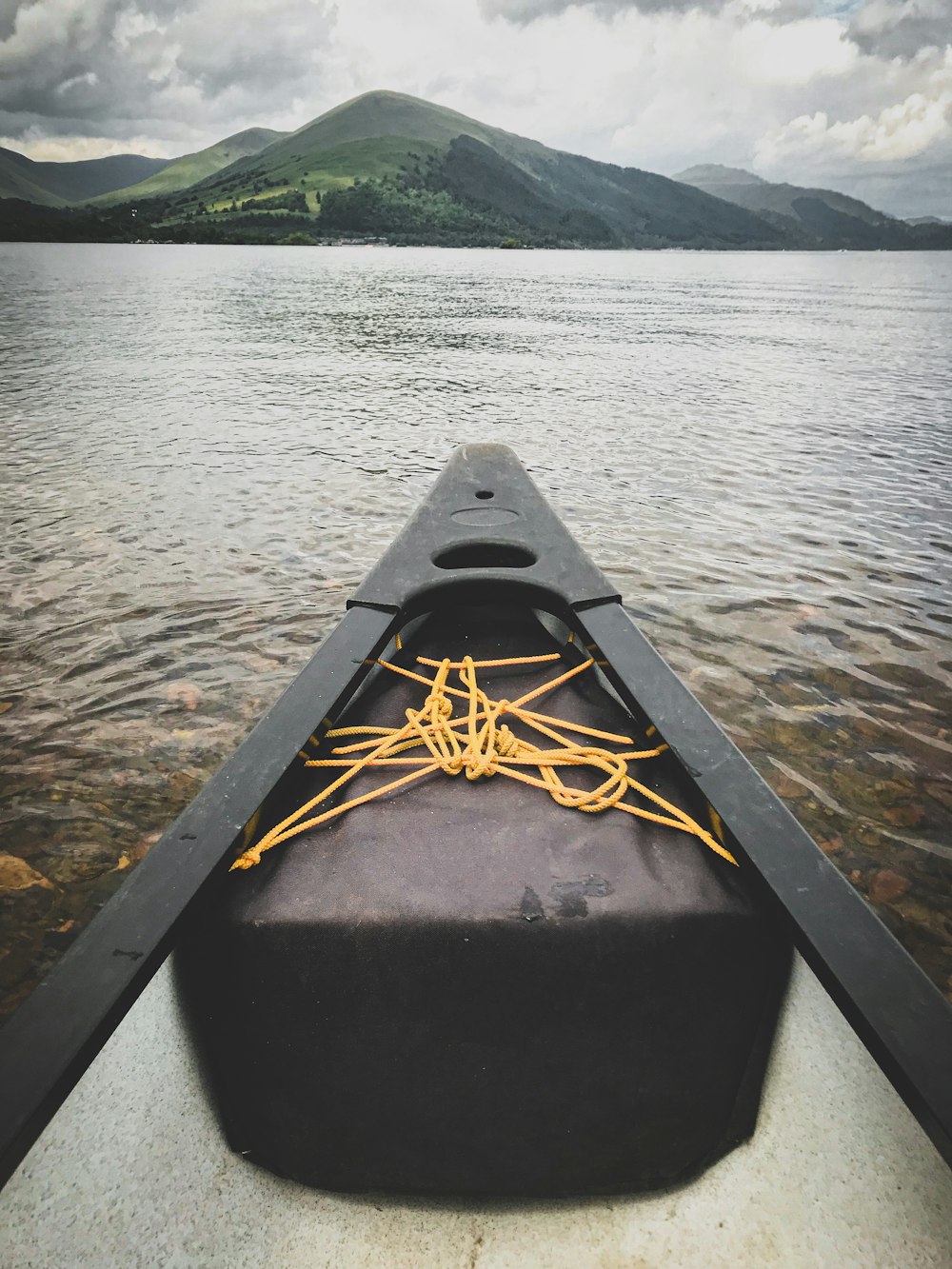 black kayak on body of water during daytime