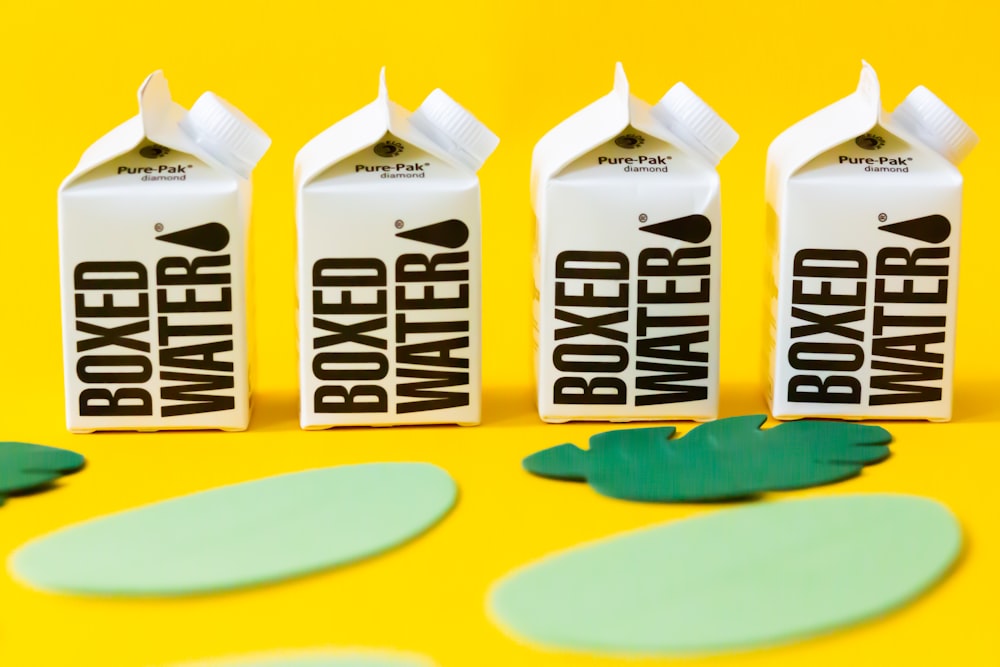 two white and blue milk carton on yellow and blue table