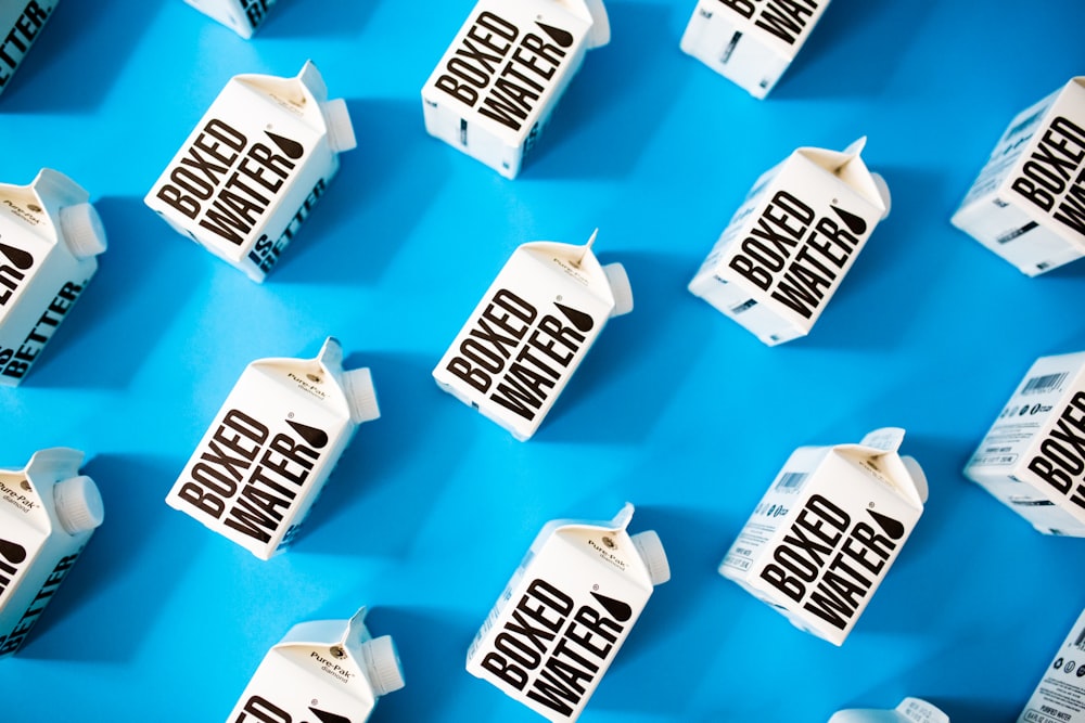 a group of milk cartons sitting on top of a blue surface