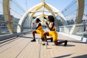 Elevé Group woman in yellow shorts sitting on yellow chair