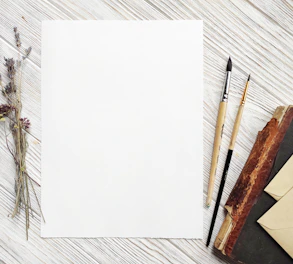 A stack of pristine white sheets resting on a wooden desk, inviting creativity.