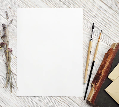 A stack of pristine white sheets resting on a wooden desk, inviting creativity.