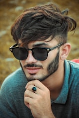 man in black sunglasses and gray hoodie