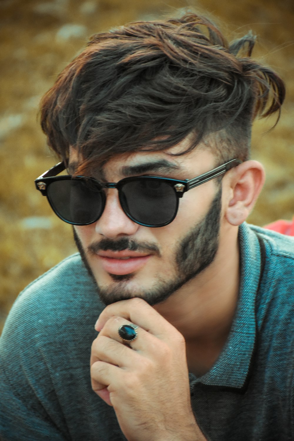 Hombre con gafas de sol negras y sudadera con capucha gris