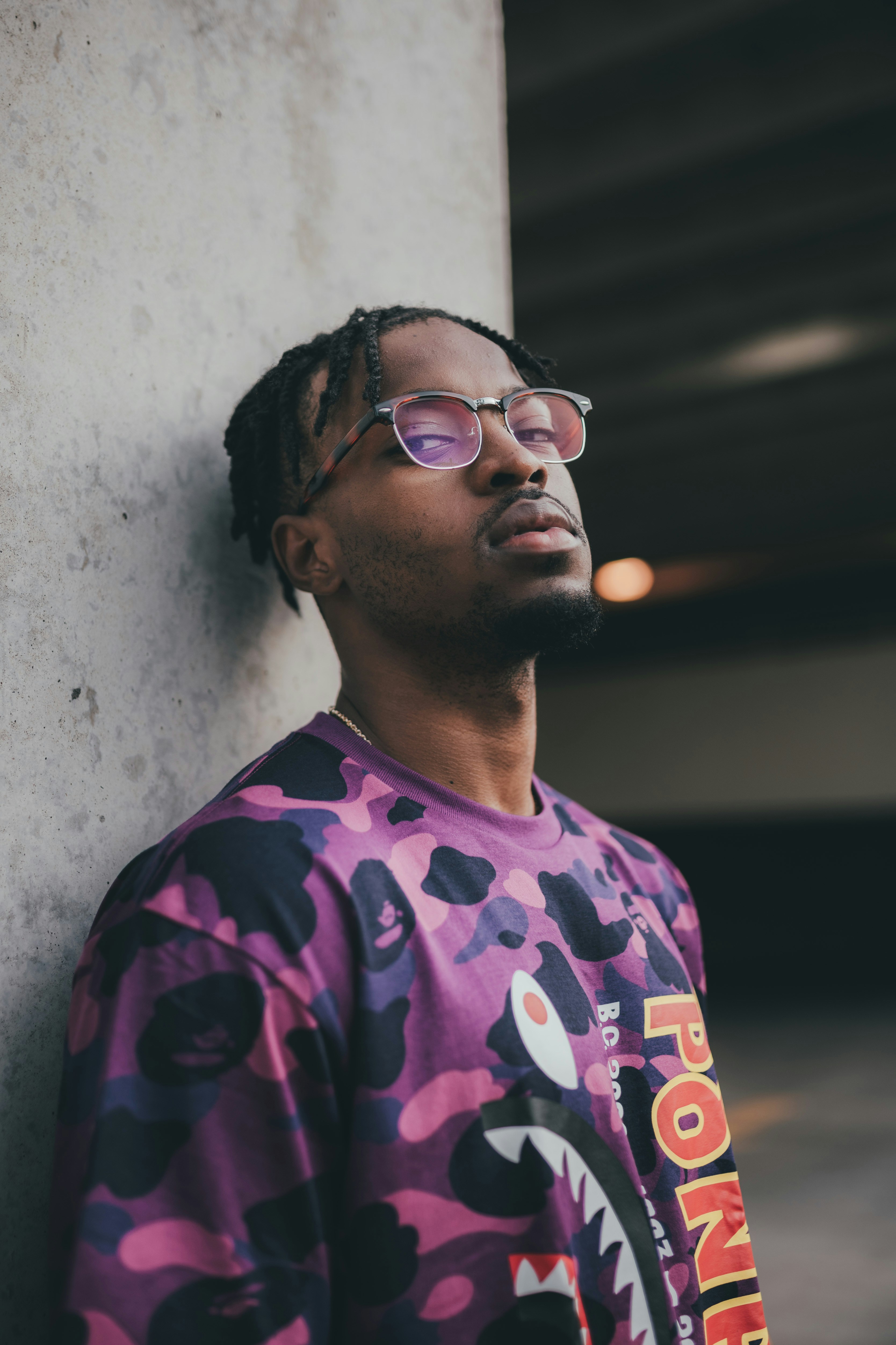 man in purple crew neck shirt wearing brown sunglasses