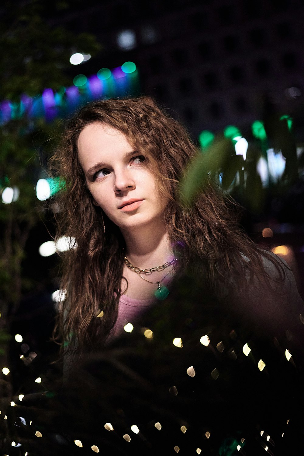 woman in black shirt with string lights on her head