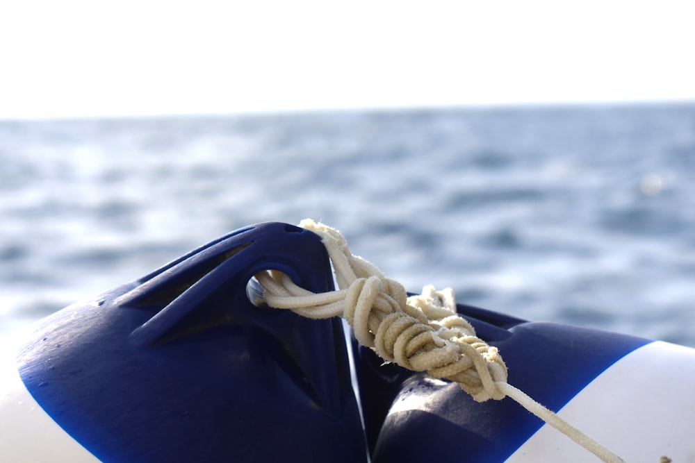 blue and white boat on body of water during daytime