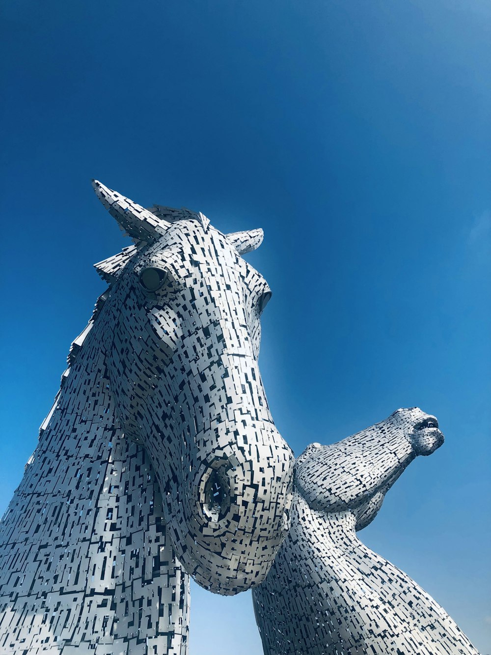 grey dragon statue under blue sky